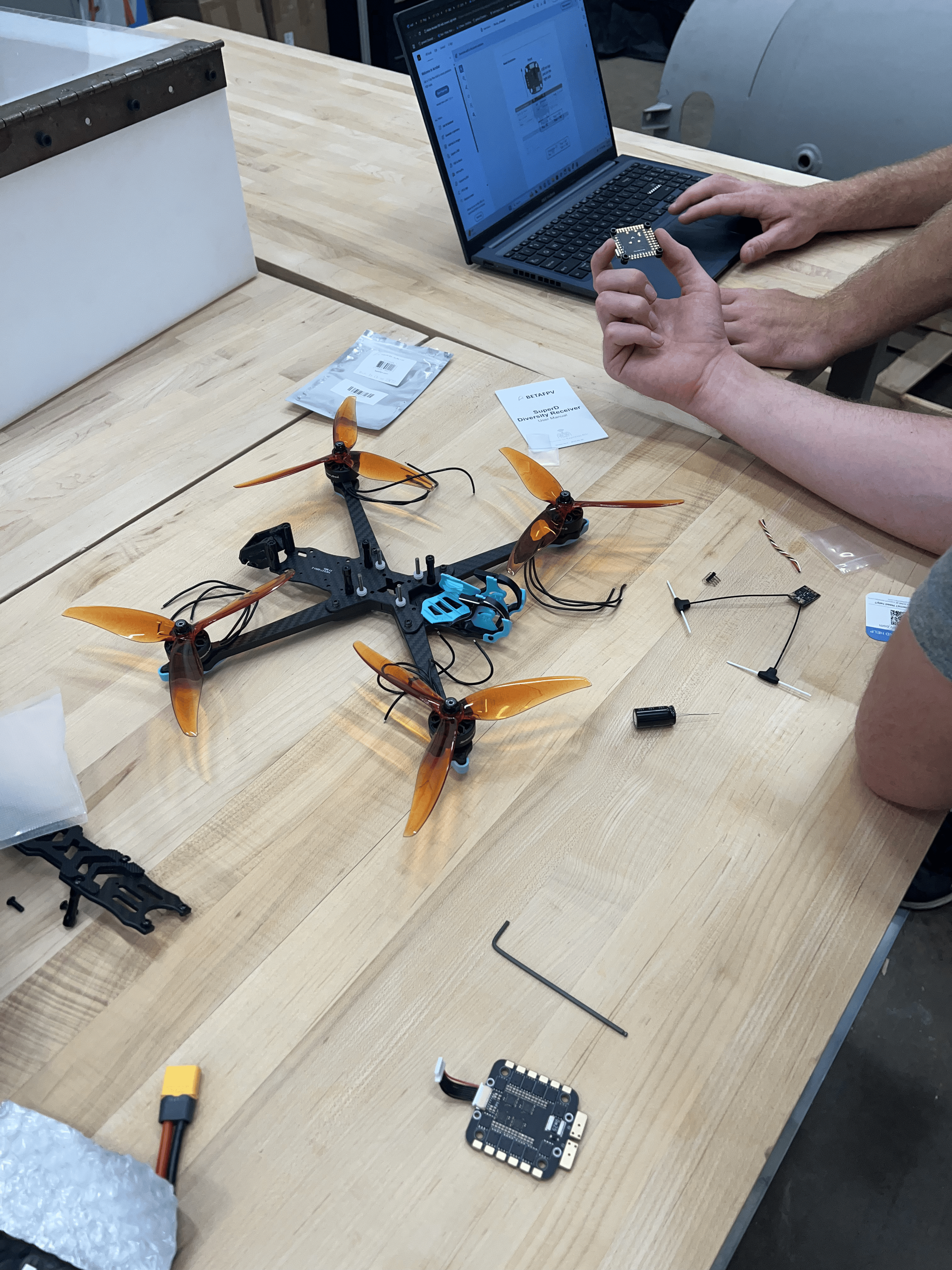 Drone build in progress — carbon frame and ESC wiring